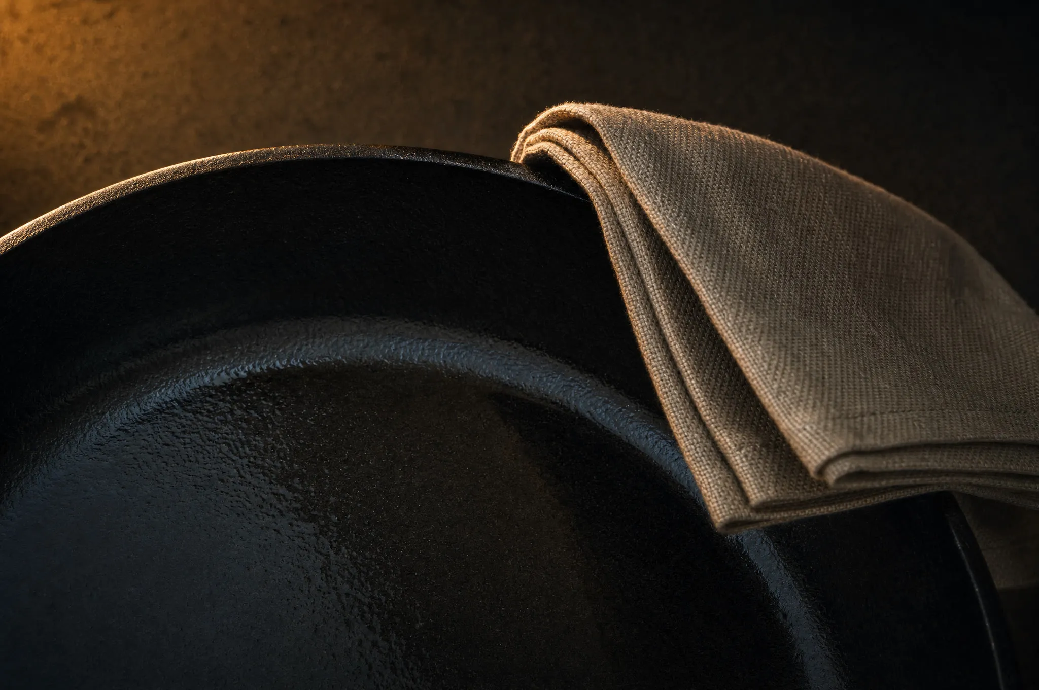 A thin sheen of oil on cast iron, wiped back until the pan looks dry